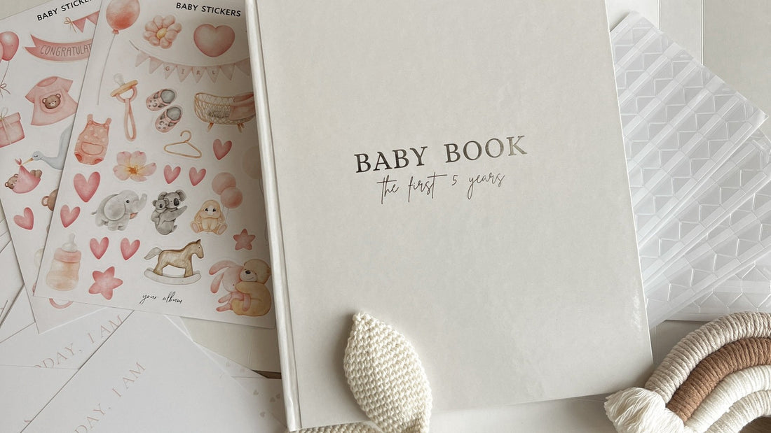 Baby memory book open with milestone pages and photo corners