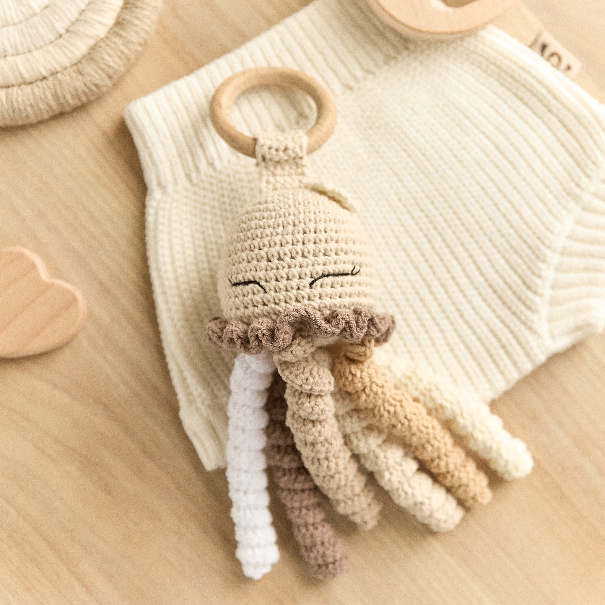 Handmade crochet jellyfish baby rattle with curly tentacles and wooden teething ring