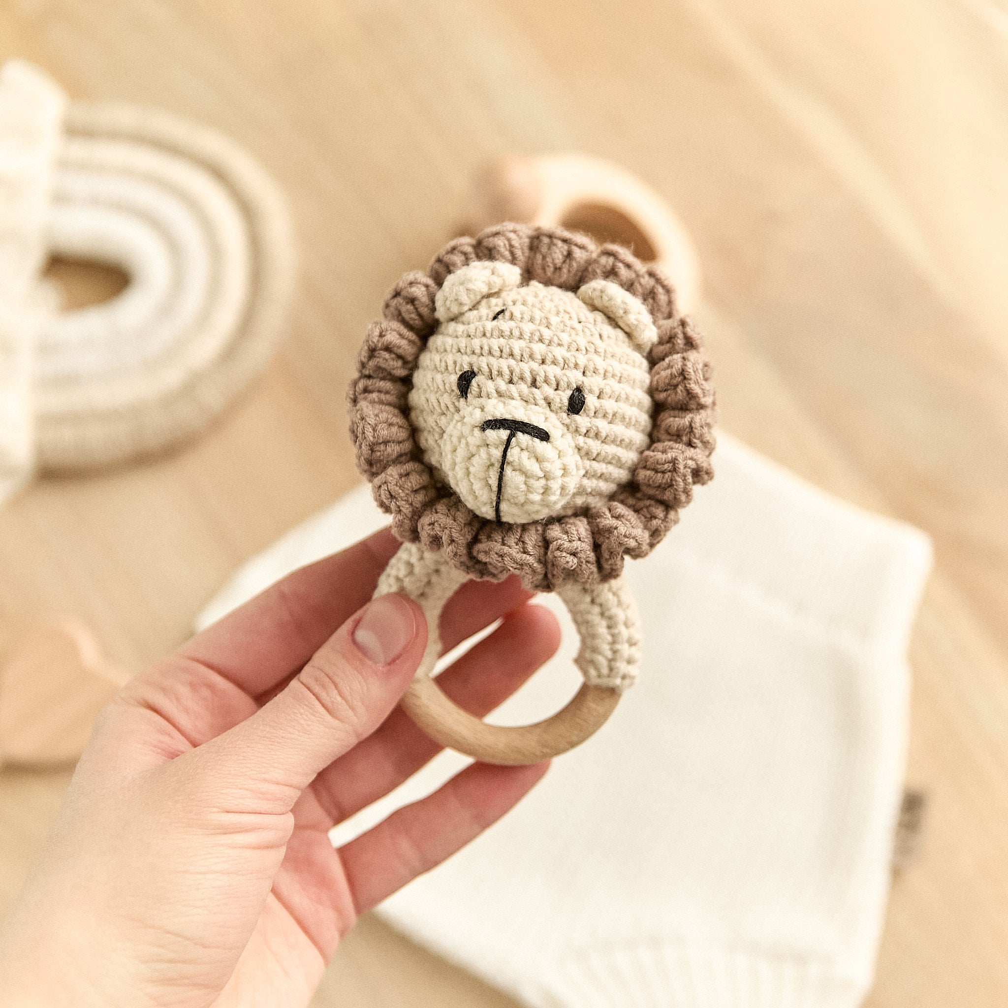 Handmade crochet bear baby rattle with fluffy mane and natural wooden teething ring