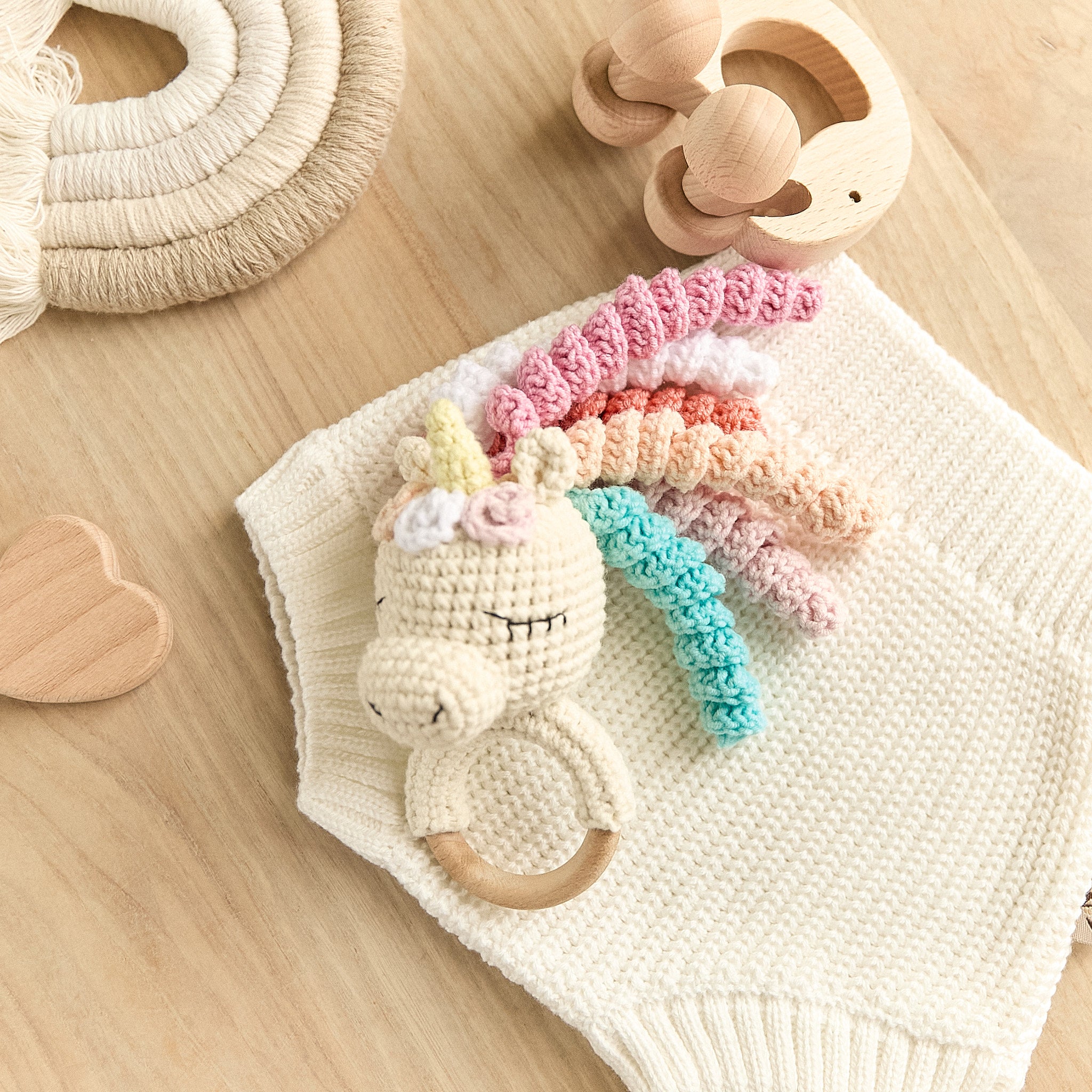 Handmade crochet unicorn baby rattle with rainbow mane and wooden teething ring