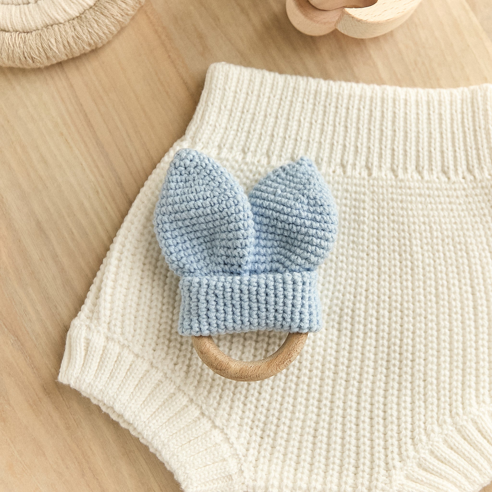Crochet blue bunny ear teether with natural wooden ring — newborn sensory toy