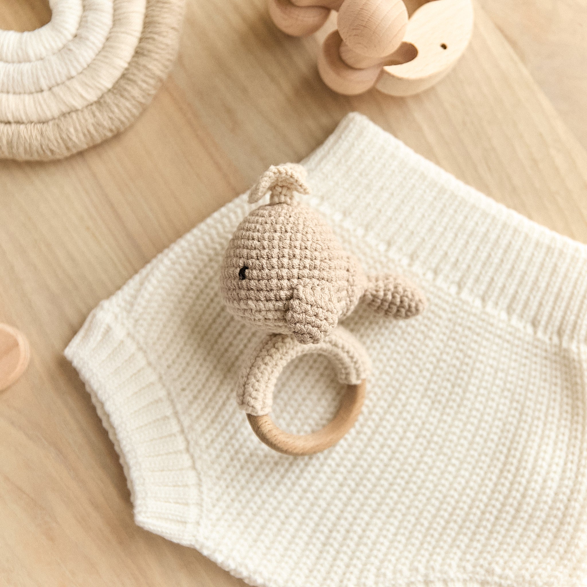 Handmade crochet whale baby rattle in beige with natural wooden teething ring