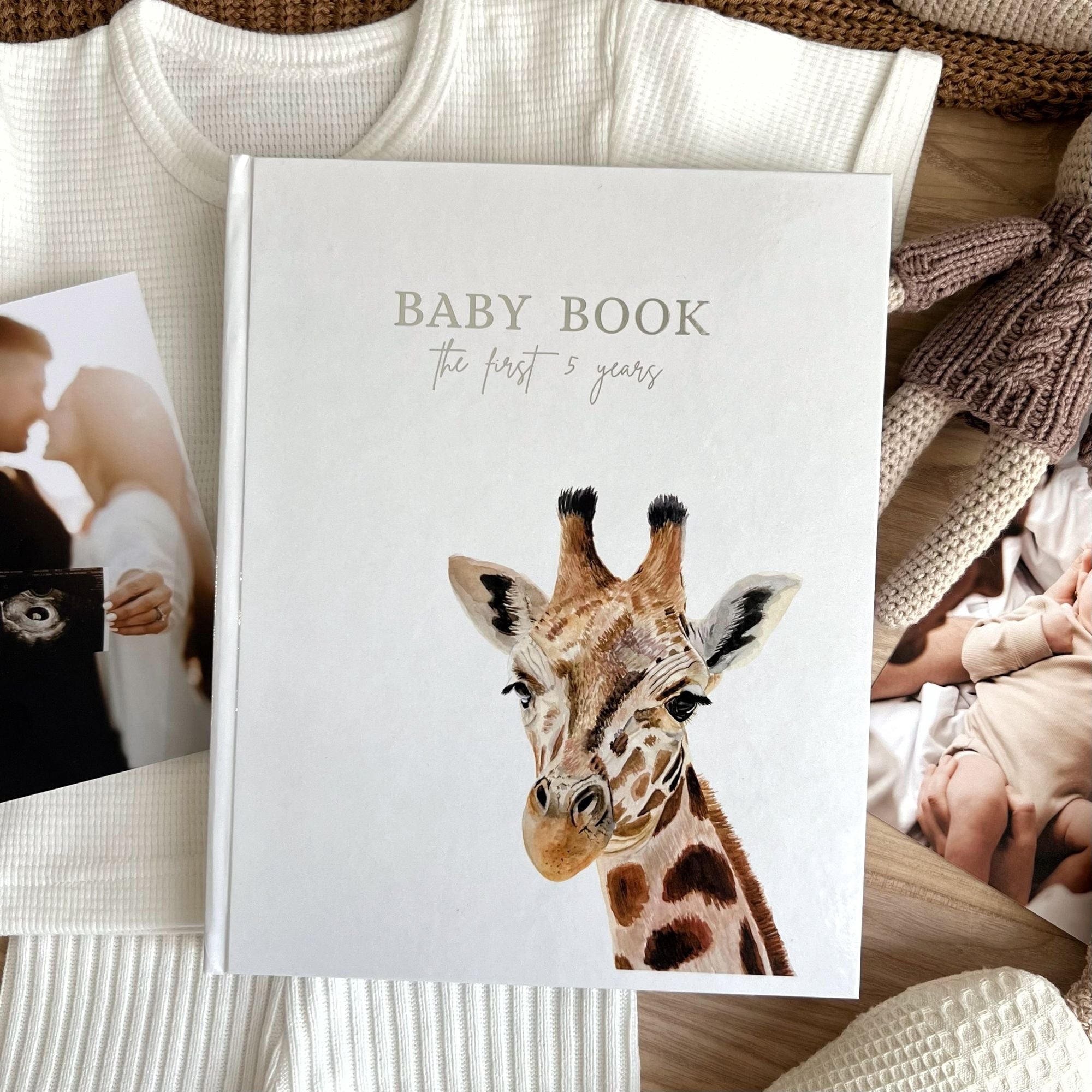 Baby memory book cover design with cute giraffe illustration on linen
