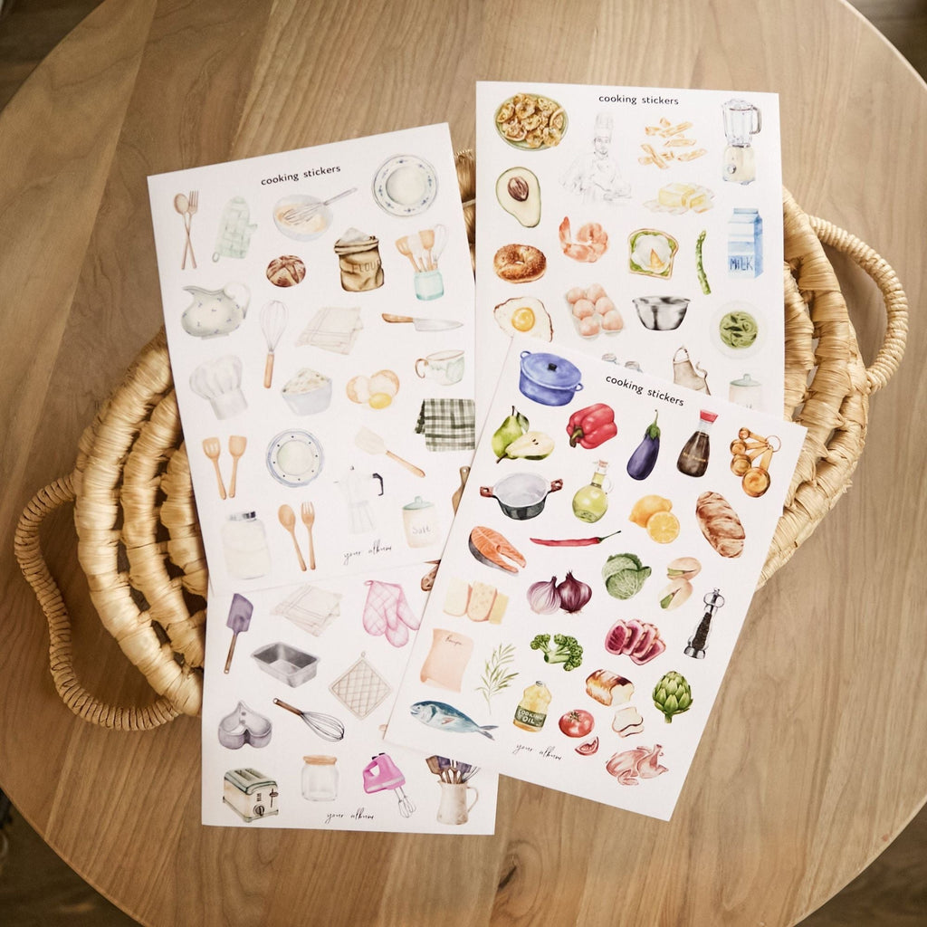 Baking stickers styled on wooden cutting board with kitchen props flat lay
