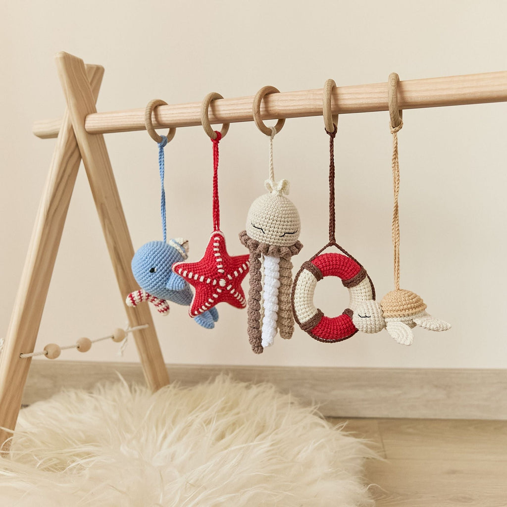 Crochet hanging toys close-up showing cotton yarn texture and teething elements