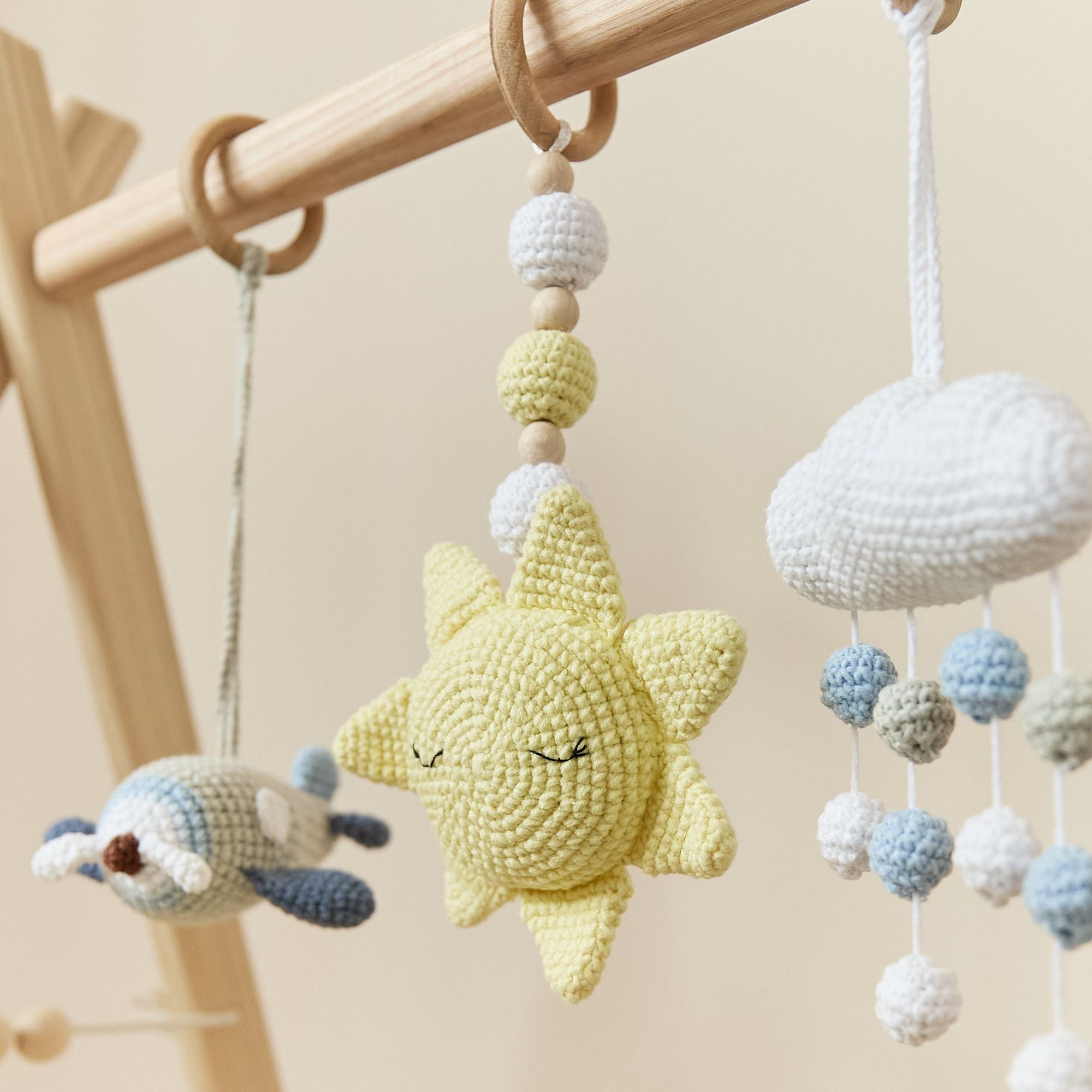 Crochet toy detail showing natural wood teething ring and cotton yarn animal