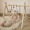 Handmade Montessori wooden baby play gym with natural ash wood frame — nursery lifestyle