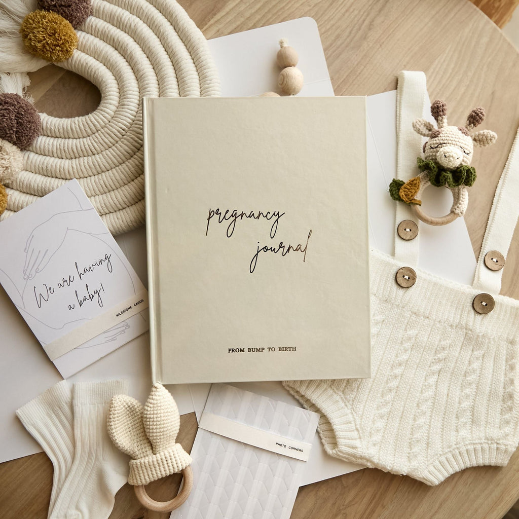 Pregnancy journal held in hands showing book size and premium cover quality