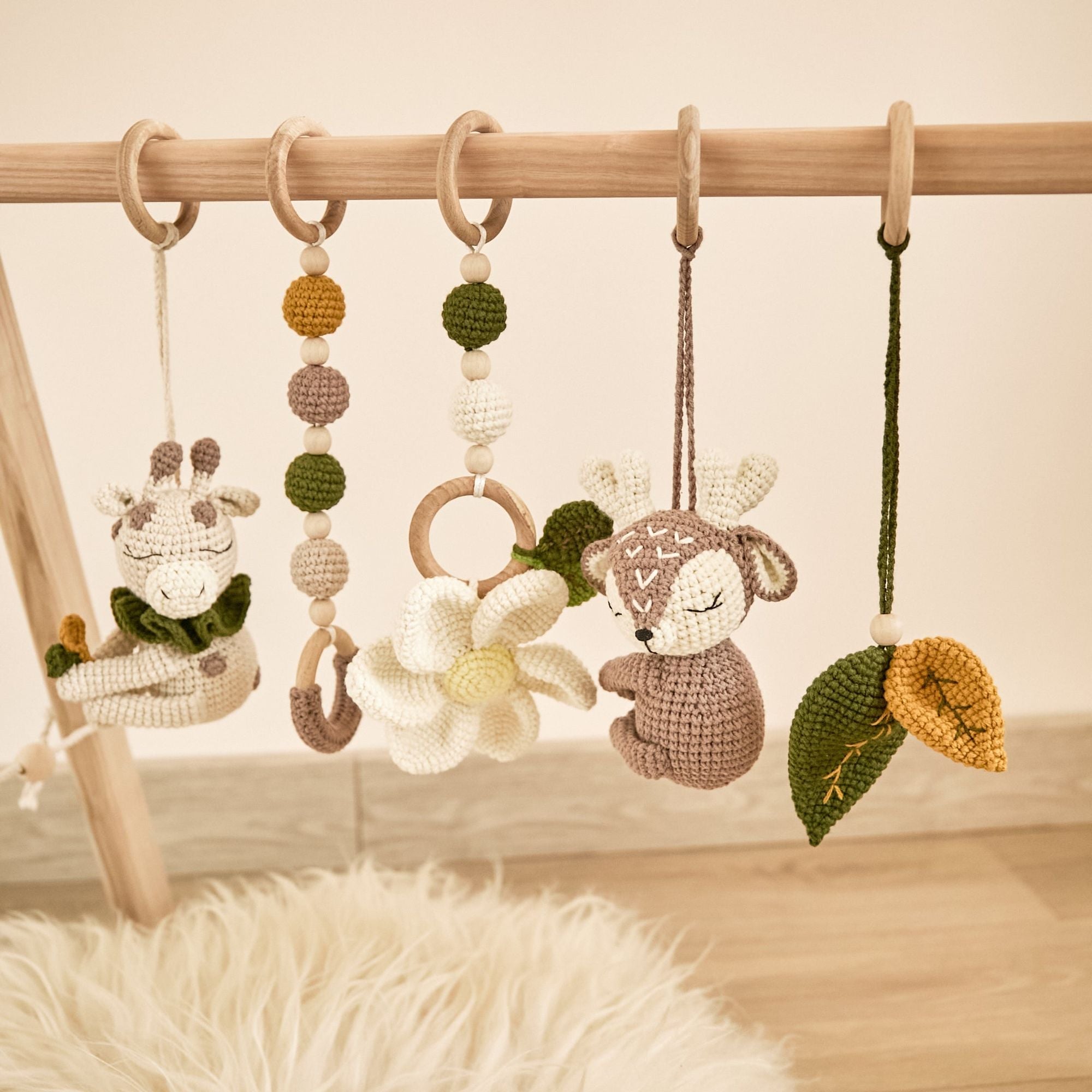 Real product photo of wooden baby play gym assembled on nursery rug