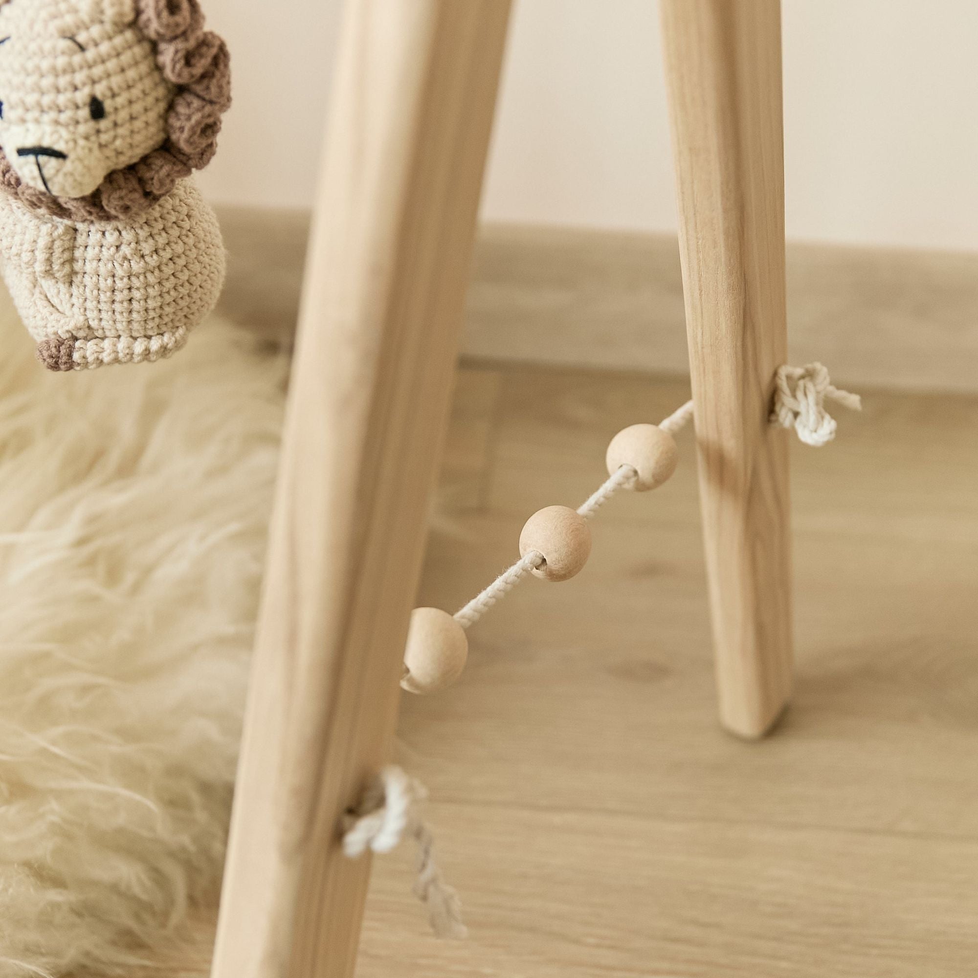 Wooden Montessori play gym with crochet toys — newborn gift packaging view